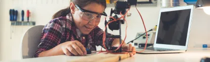 Child working with electronics.