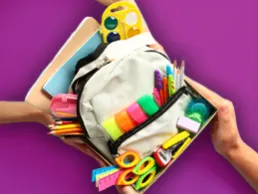 Photo of a box holding donated school supplies. 