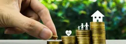 image of a person stacking coins to save for life events