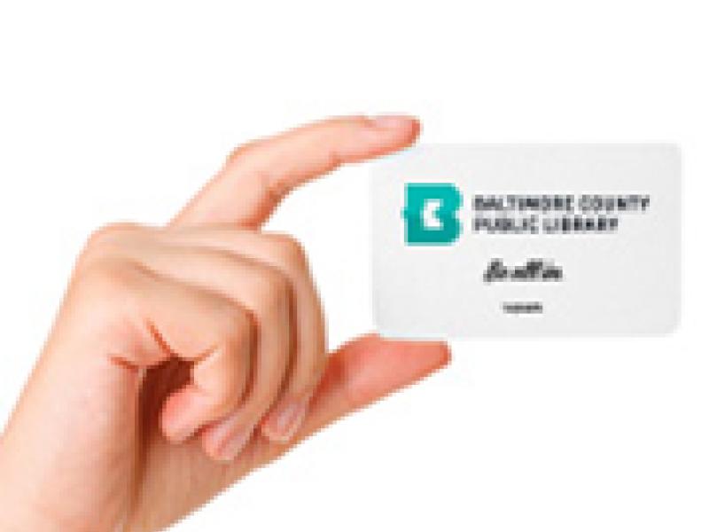 An hand holding a BCPL library card.