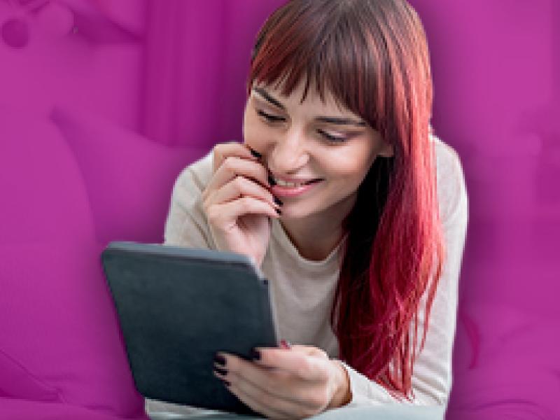 photo of a woman reading a tablet