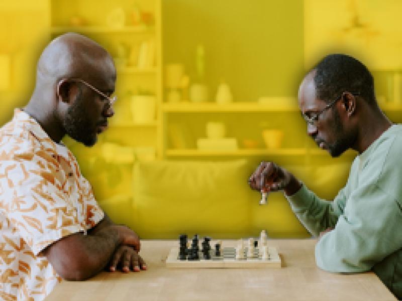 photo of two men playing chess