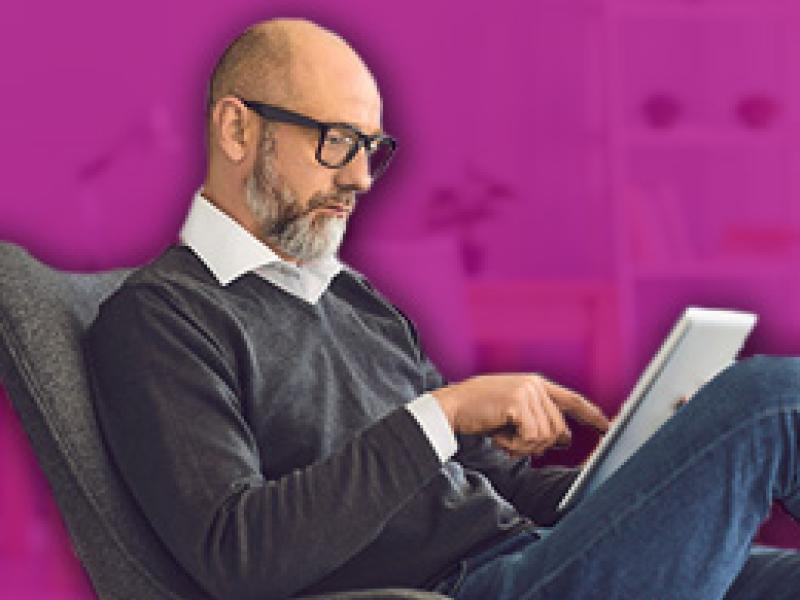 photo of a man reading from a tablet