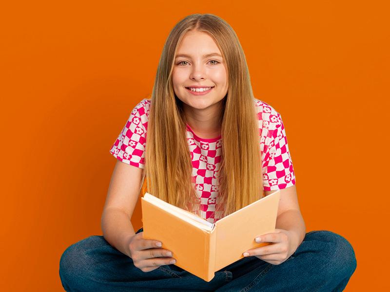 Photo of a girl smiling with a book