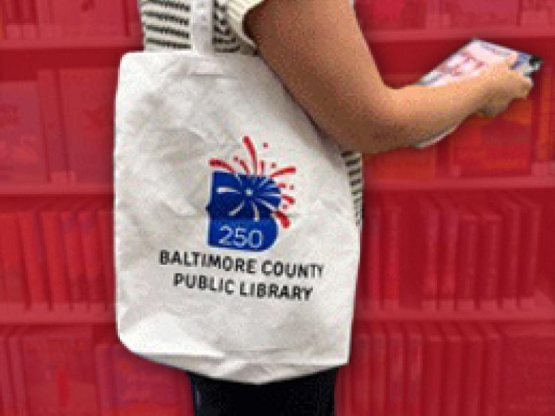 a woman holding a tote with the B250 logo on it. 
