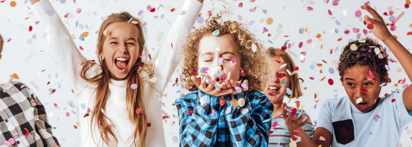 Children celebrating amidst confetti