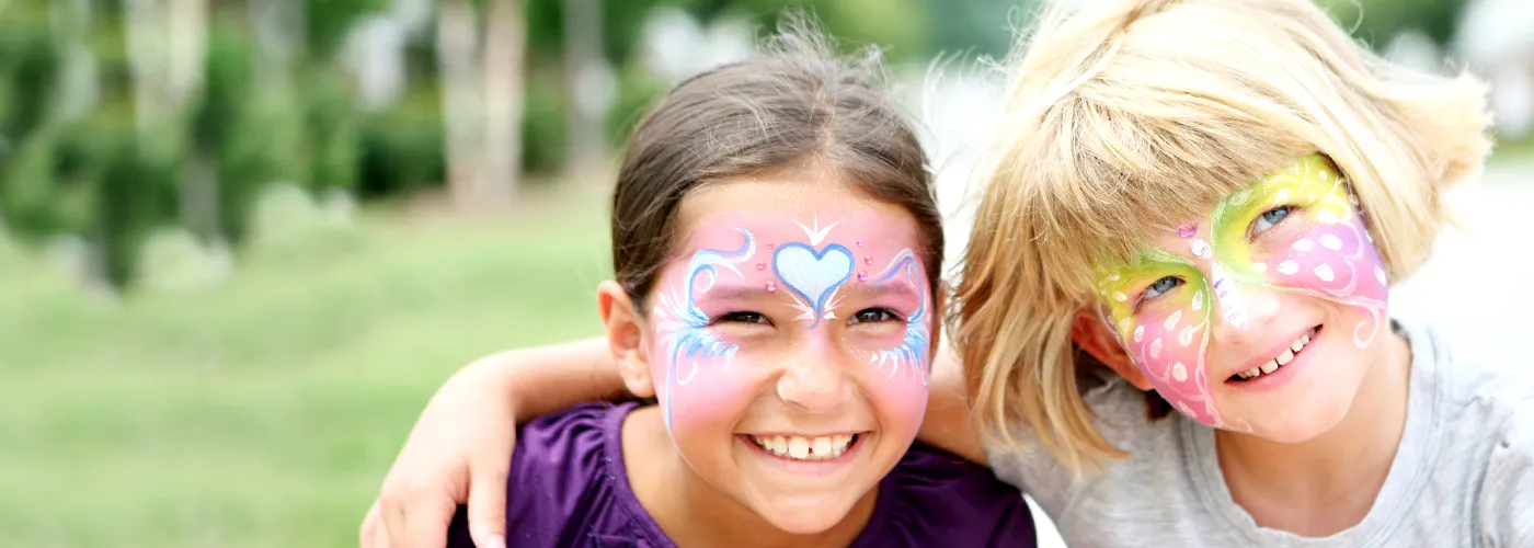 two girls smiling after getting their faces painted