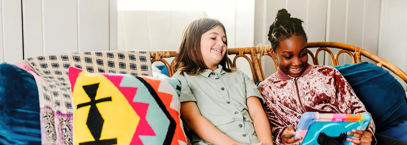 Photo of two girls in pajamas reading