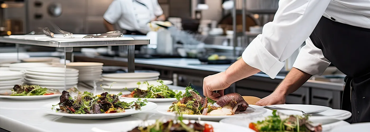 chef preparing multiple fancy dinner plates