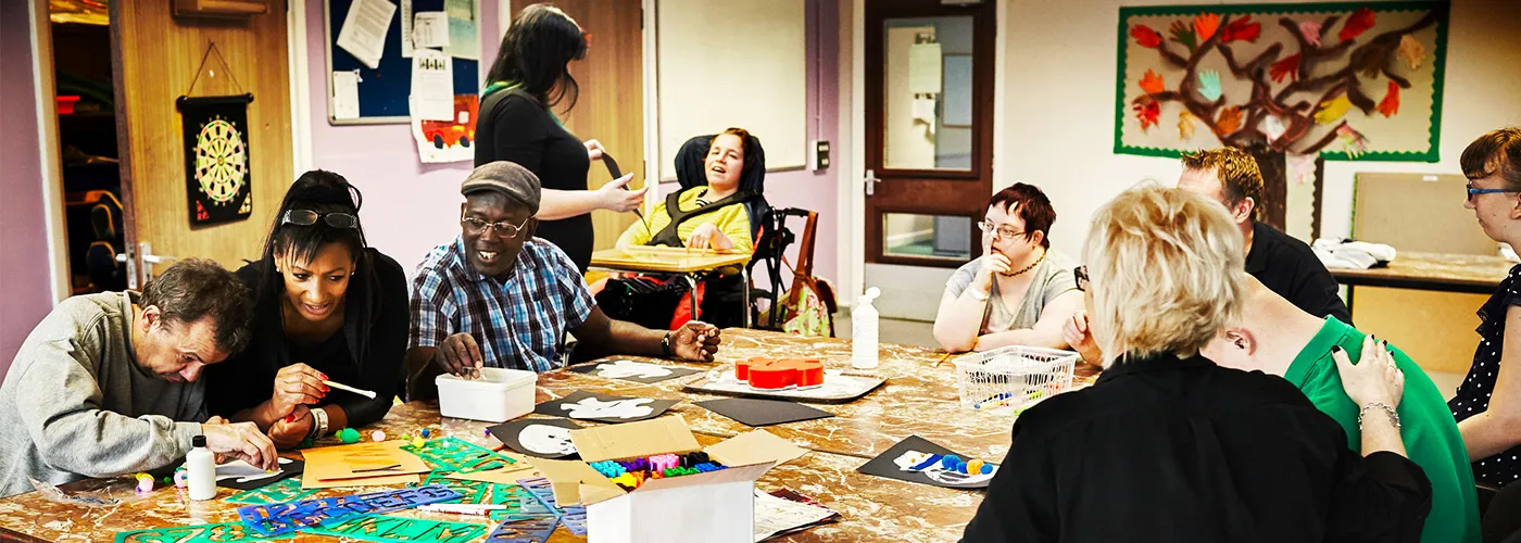 Photo of a diverse group of people doing crafts and art