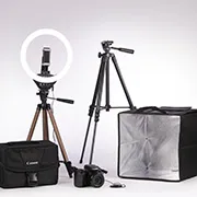 An example of a camera kit with a tripod, camera, camera bag, and various lights.