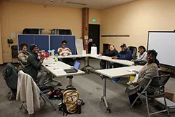 A photo of a group of people sitting around a table